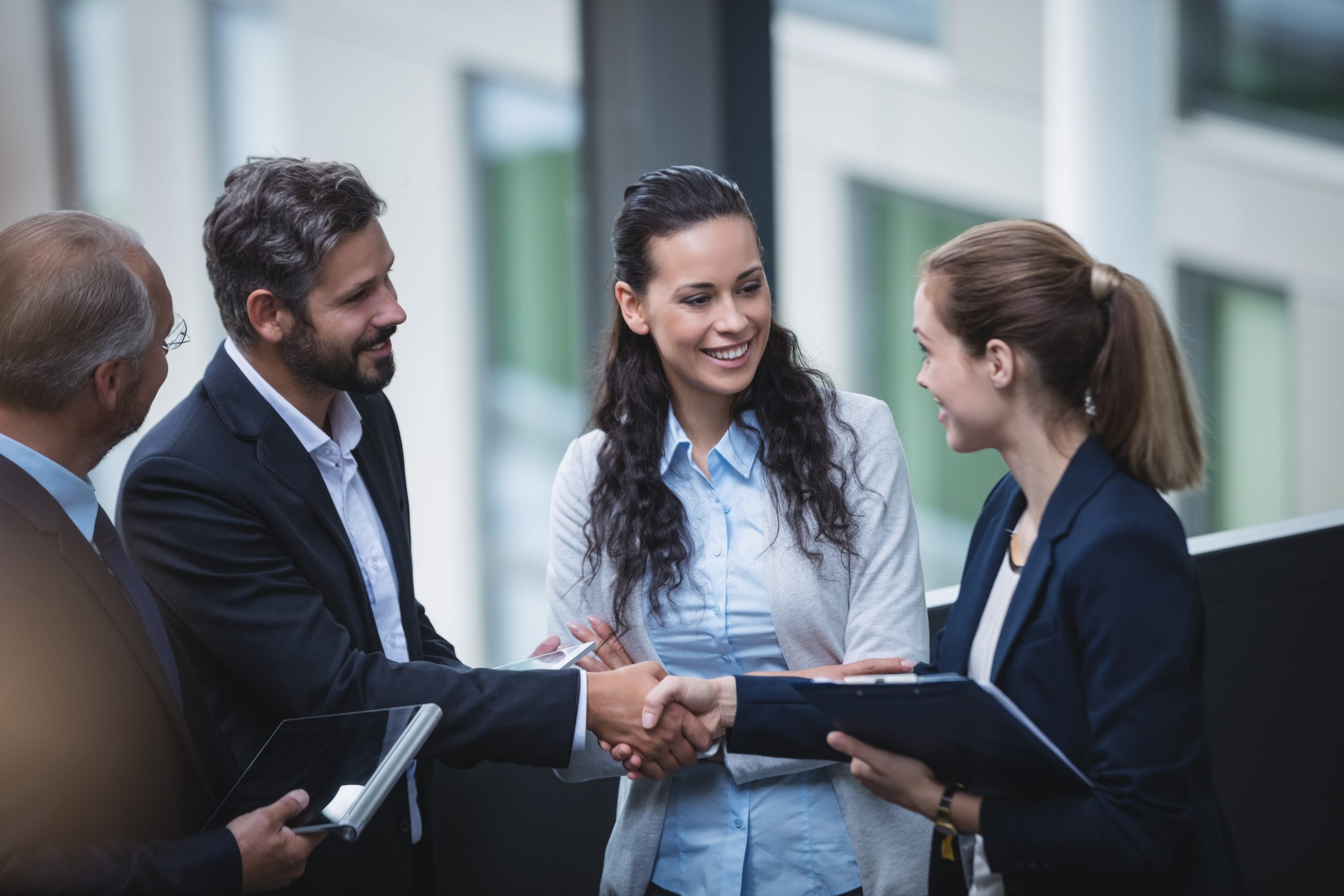 Group of businesspeople having a discussion near staircase in office